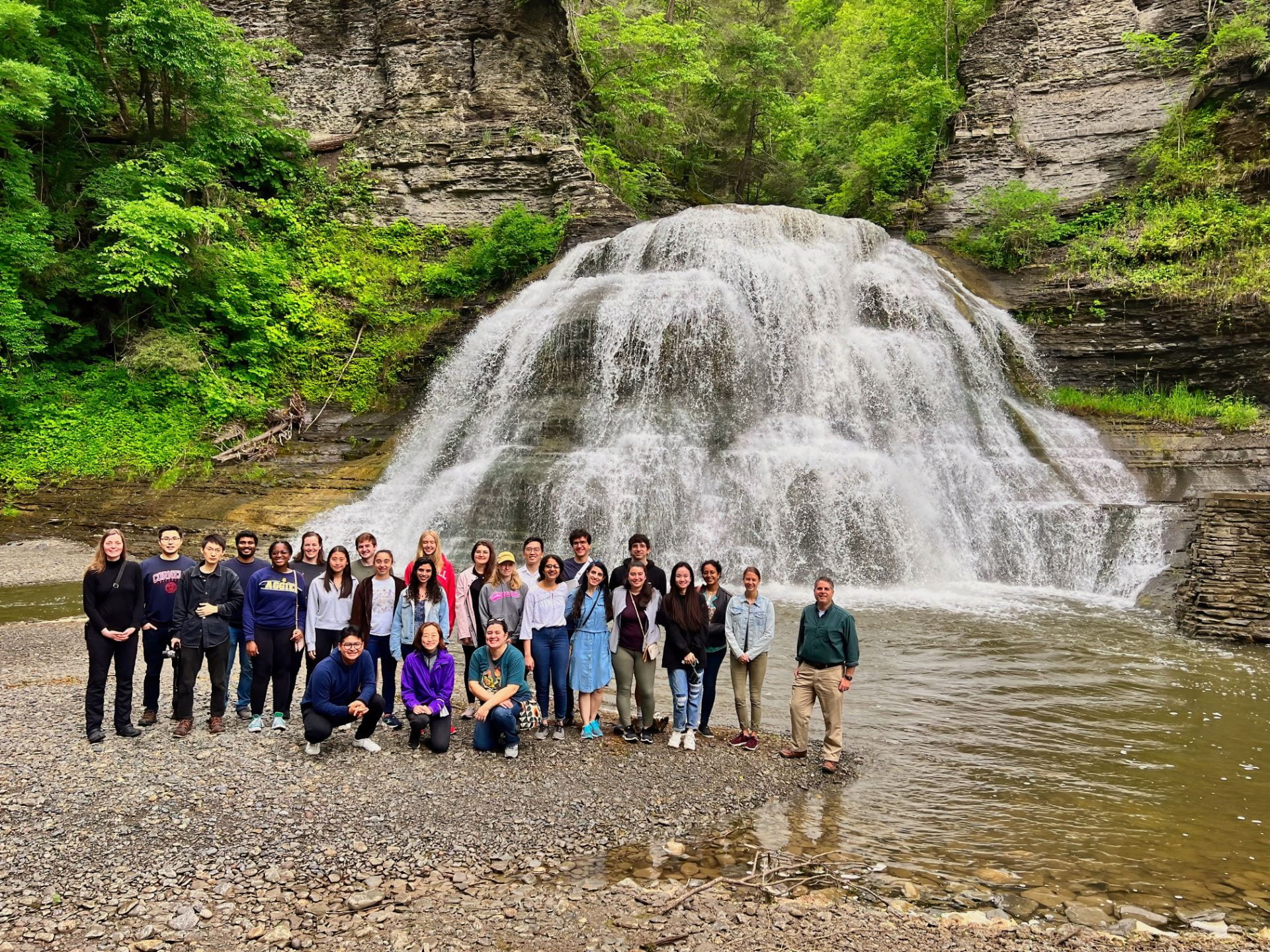 electron microscopy group in front of a waterfall